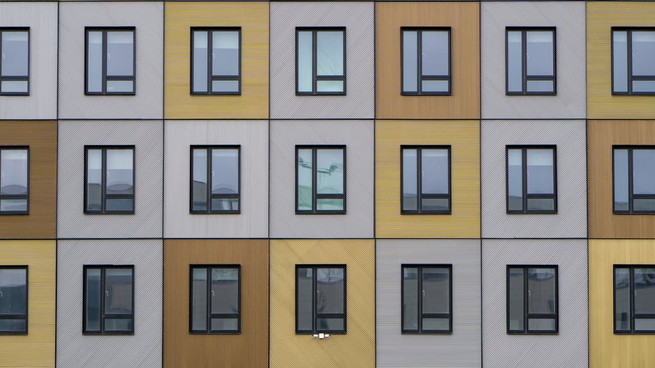 A repeating grid of identical windows across a building facade