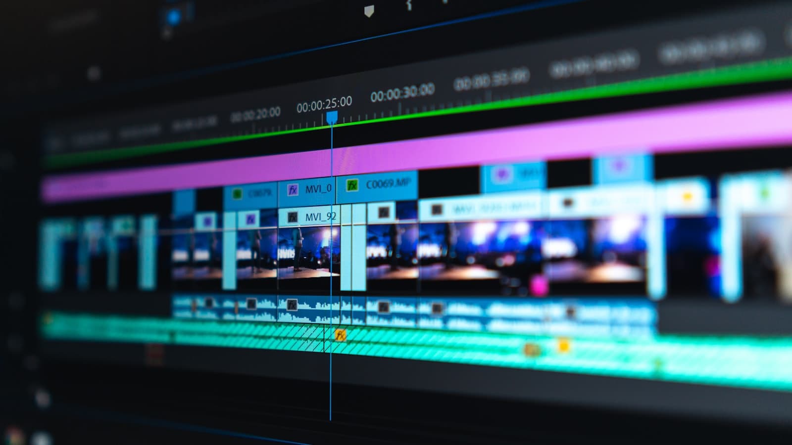 A video editing timeline with coloured clips laid out on a dark screen