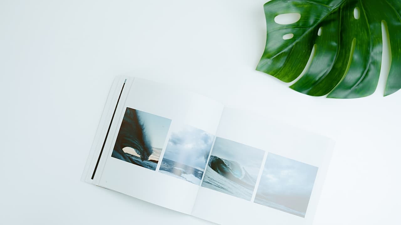 An open photography portfolio book showing a sequence of printed images