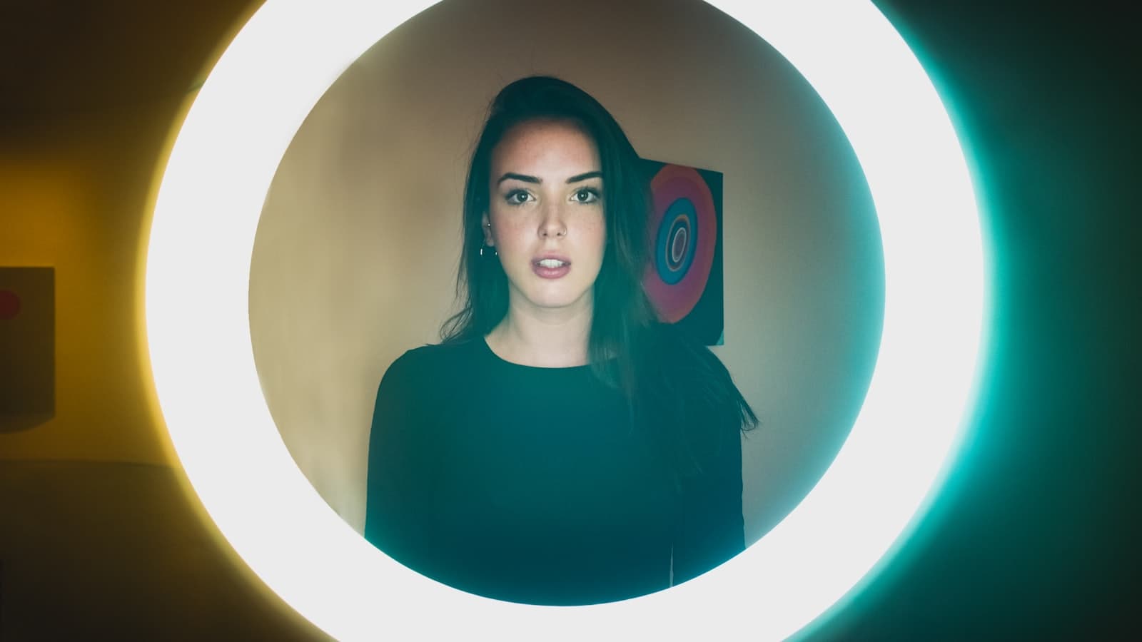 A creator filming herself on a phone in front of a mirror