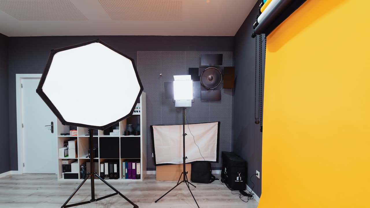 A photography studio with a light stand and tripod set up
